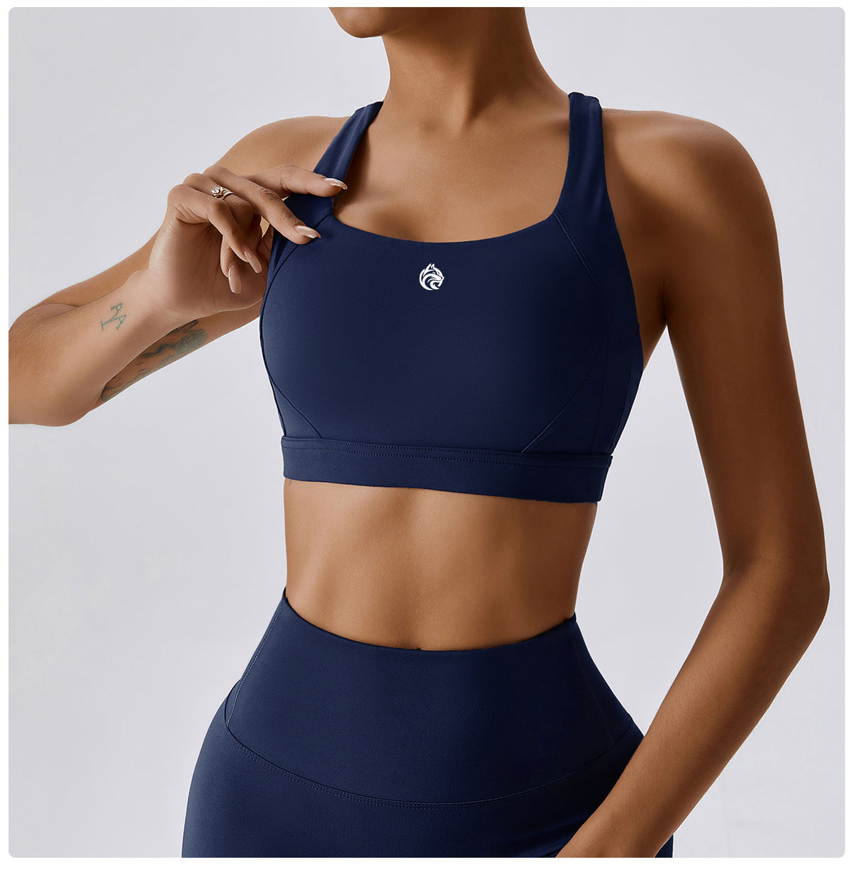 Navy blue sports bra and leggings set on a plain background